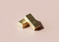 two gold bars on pink.