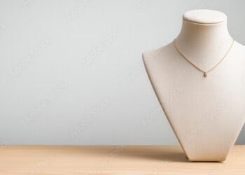 Elegant necklace displayed on a stylish jewelry bust against a neutral backdrop.