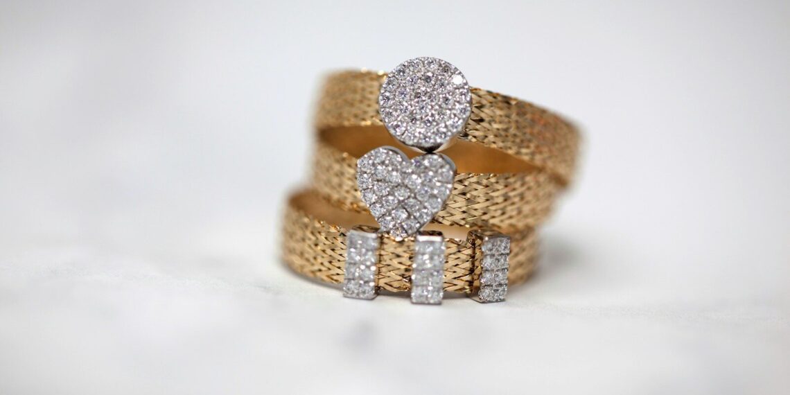 three gold-colored studded rings