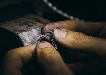 Person working on a piece of jewelry in light
