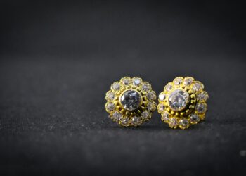 gold and silver ring on black surface