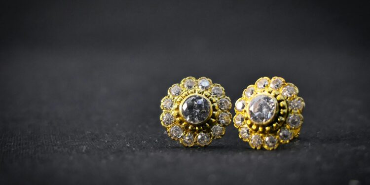 gold and silver ring on black surface